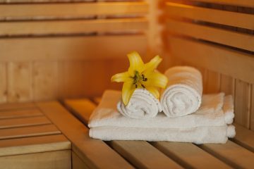 close up fresh towels and yellow lily in sauna